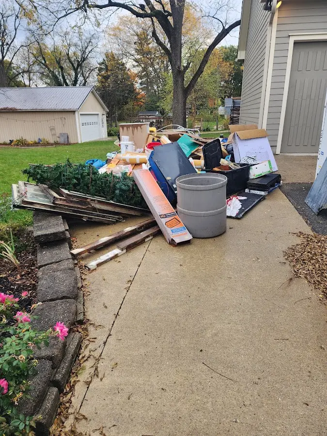 Dumpster being loaded with debris for 10 Yard Dumpster Rental in Darlington